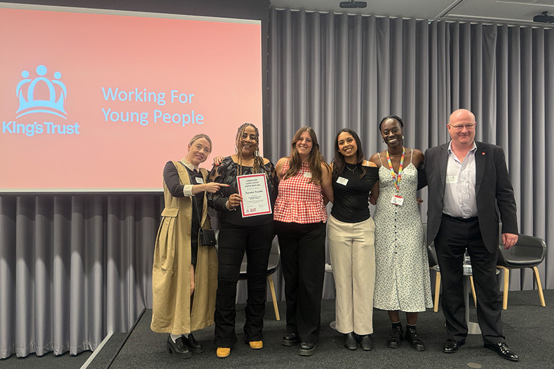 Sheromie collecting her award